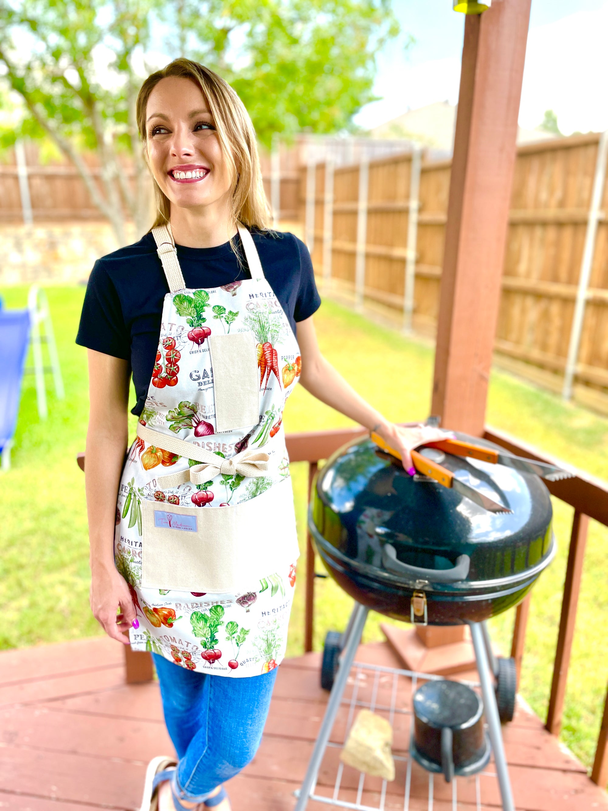 Two Medium Sized Ladies outdoor grilling with vintage style in the 100 percent cotton Lanie farmers market apron